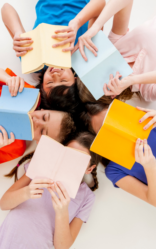 five kids laying on their backs in a circle each reading a different book